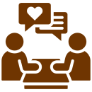 Mask group-2 Two simplistic figures sit at a table, conversing. Speech bubbles above show a heart and text, suggesting a friendly or romantic discussion.